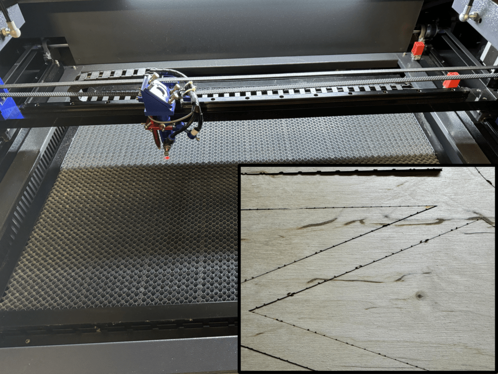 View inside a CO2 laser with a honeycomb table. Next to it, a wooden board from below with black spots on the cut edges